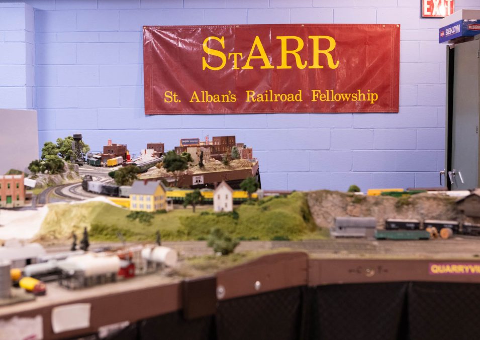 Photo of model railroad setup in the basement of St. Alban's Episcopal Church in Newtown Square, PA. The St. Albans Railroad Fellowship sign hangs on the wall.